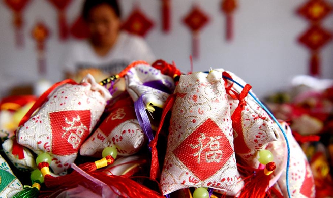 Workers make sachets for upcoming Chinese traditional Duanwu Festival in Shanxi