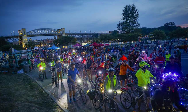 People participate in "Bike the Night" event in Vancouver